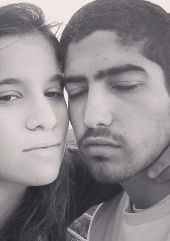 An intimate black-and-white close-up of Ziv Hagbi with a woman, their faces gently touching
