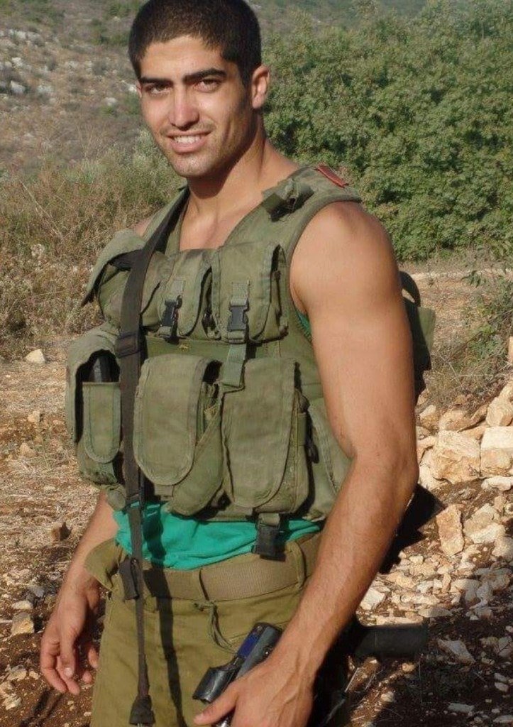 Ziv Hagbi in military gear, smiling in an outdoor landscape during his service