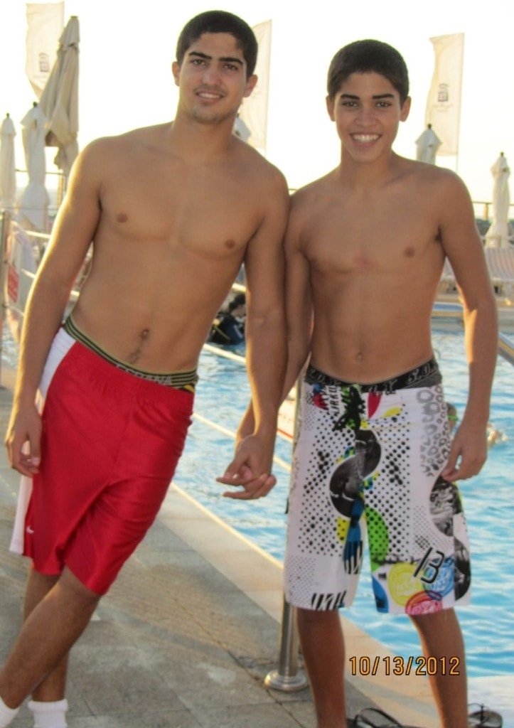 Ziv Hagbi and a friend smiling together by a swimming pool in October 2012