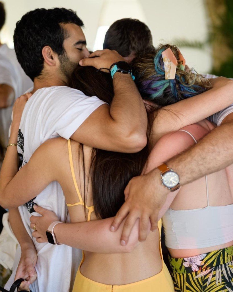 A group embrace including Omri, Shahar and Danielle.