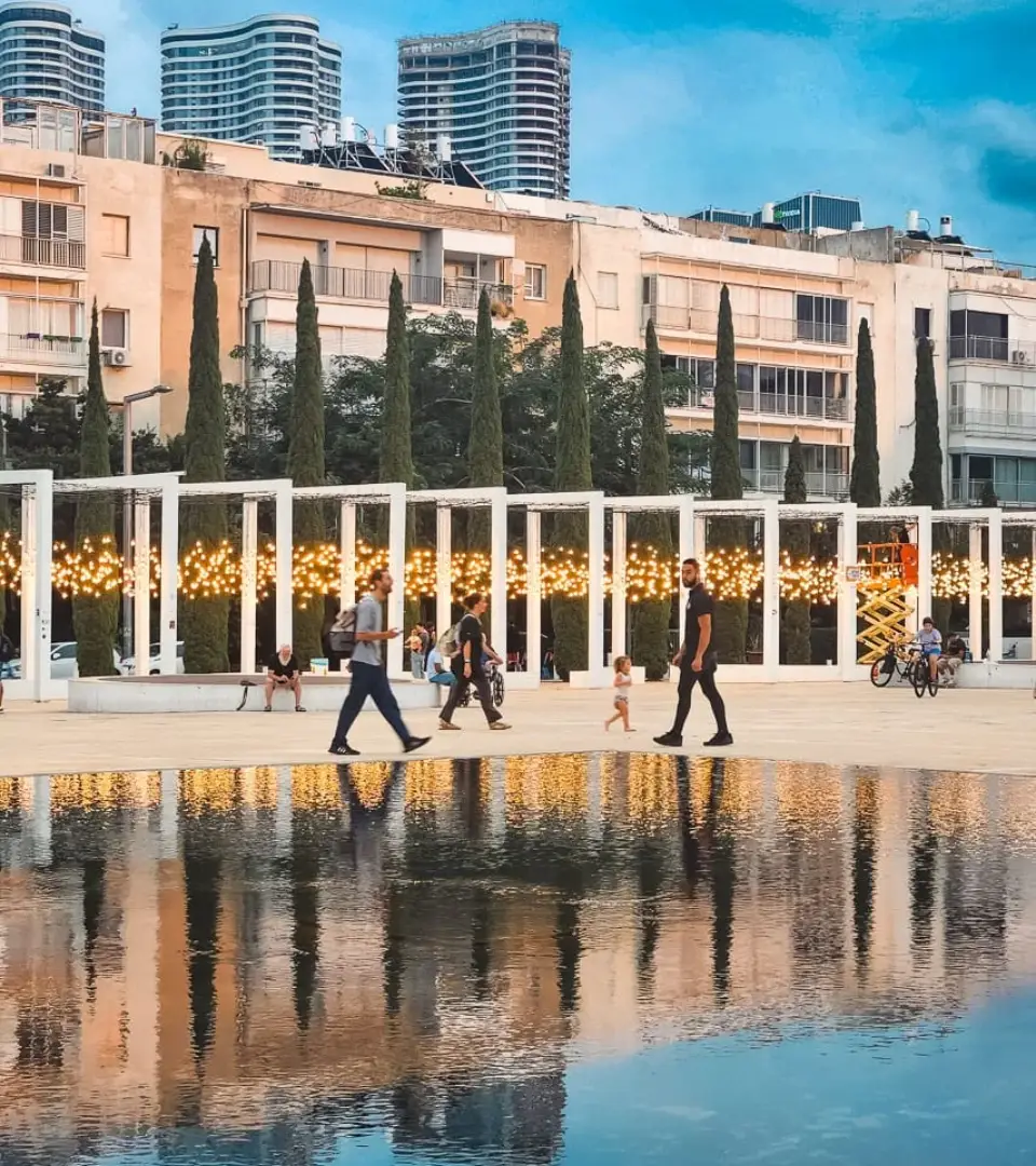 The Light Monument at Habima Square at night, with rows of warm memorial bulbs honoring lives lost on October 7, 2023
