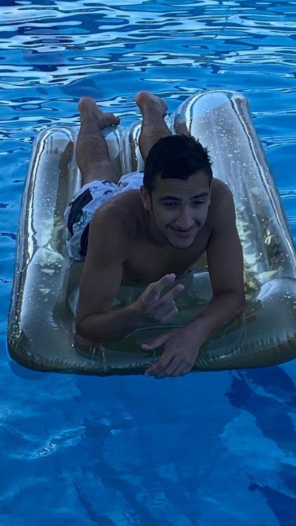Shaked Dahan smiling on a pool float