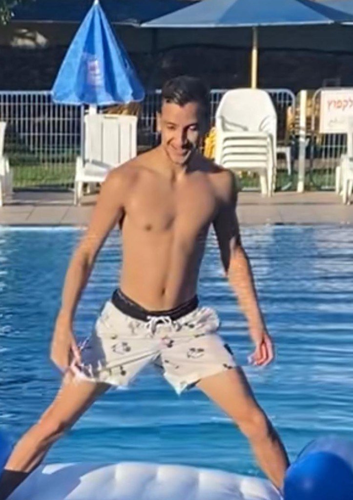 Shaked Dahan standing on a pool float, smiling