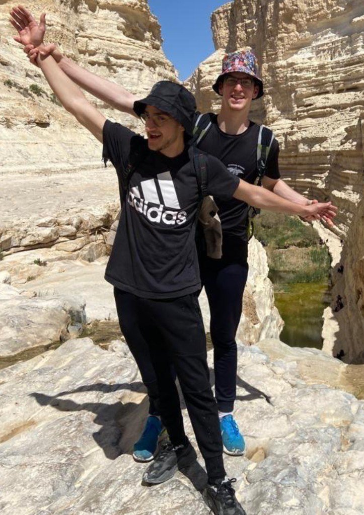 Shaked Dahan with a friend posing on a desert cliff