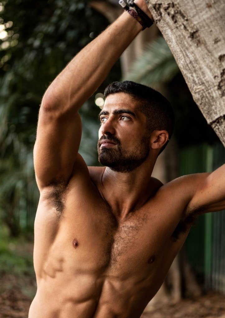 Ziv Hagbi at the Nova festival, leaning against a tree with a calm, reflective expression